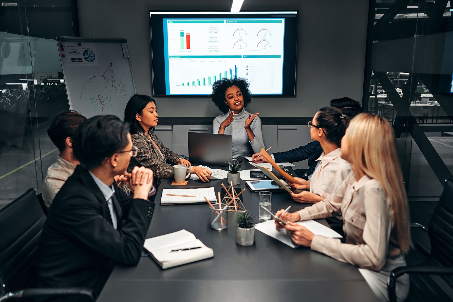 Young confident successful business people discuss and analyze work, statistics, plans, startup in a meeting room. Teamwork. Presentation.